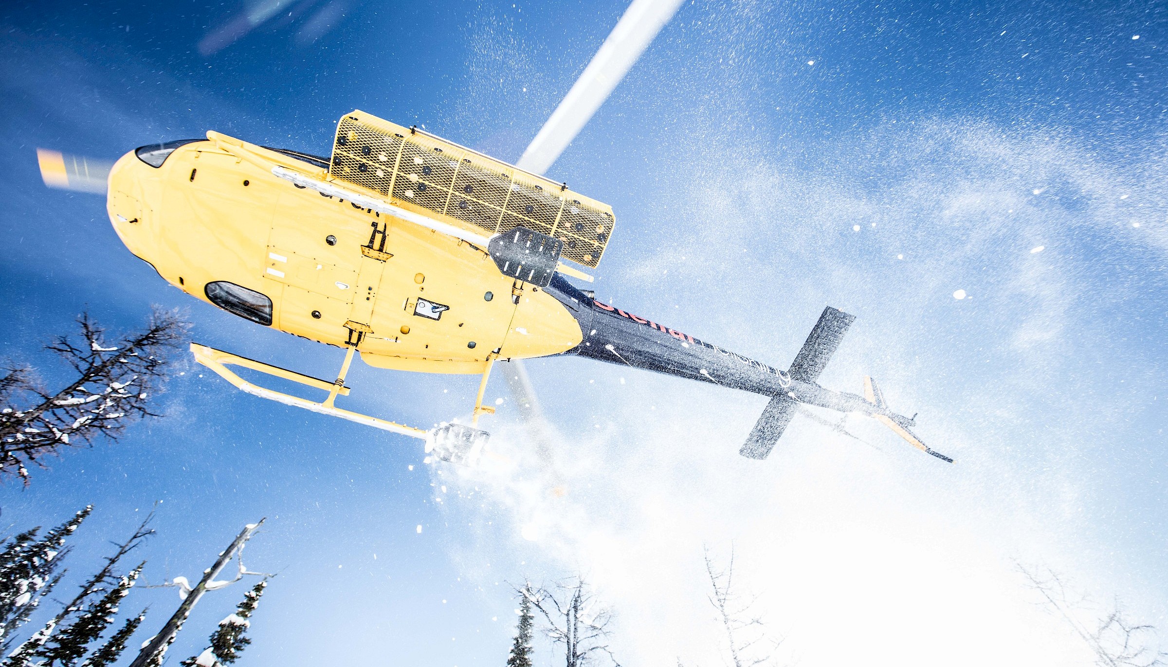 Stellar Heliskiing helicopter taking off.