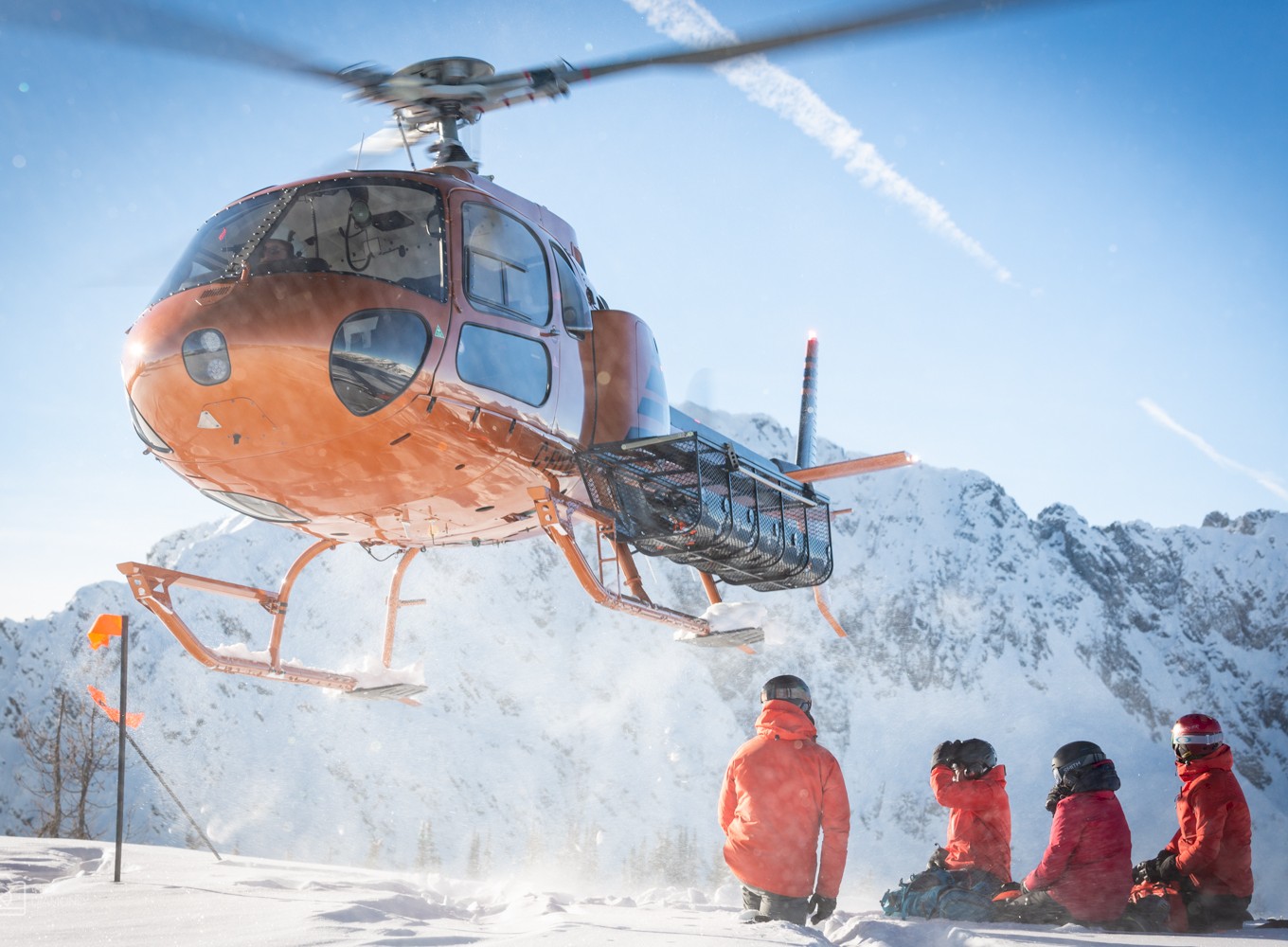 Small group safely wait at heli drop off.